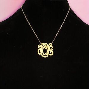 Gold tone monogram script Love necklace